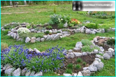 Las piedras sostienen el suelo en los macizos de flores elevados de la rocalla